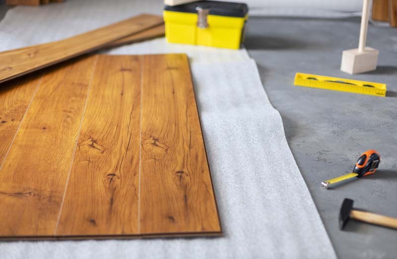 Laminate floor background texture and tools. Wooden laminate floor plank with copy space